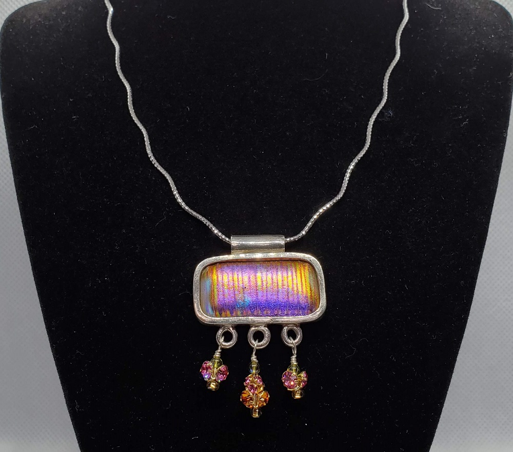 Agate pendant neckless with gold color bail and sides and a lace strap with gold color clasp.