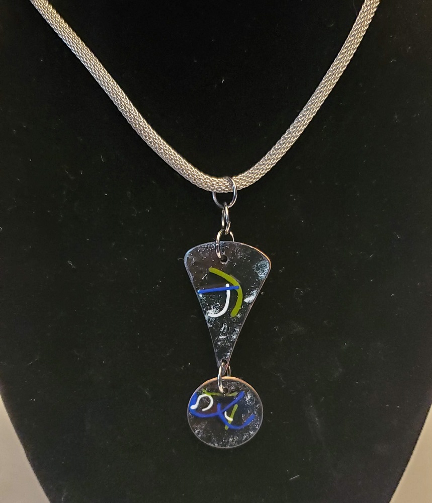 Black with blue, green & white enamel on copper pendant by Steve and Calisse Browne, Metal Memories